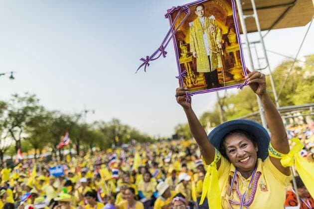 May 5, 2014 - Bangkok, Bangkok, Thailand - A supporter of the Thai monarchy holds a photo of Bhumibol Adulyadej, the King of Thailand, over her head during a Coronation Day rally in Bangkok. Thousands of Thais packed the area around Sanam Luang and the Grand Palace Monday evening for a special ceremony to mark Coronation Day, which honored the 64th anniversary of the coronation of Bhumibol Adulyadej, the King of Thailand. Many of the people also support the anti-government movement led by Suthep Thaugsuban. Most of the anti-government protesters are conservative supporters of the monarchy. - ZUMAk94