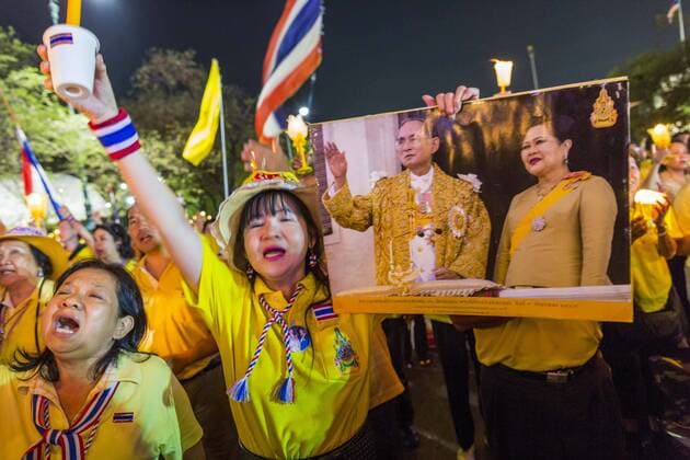 May 5, 2014 - Bangkok, Bangkok, Thailand - Supporters of the Thai monarchy sing the King s Anthem by candlelight during a vigil for the King on Sanam Luang. Thousands of Thais packed the area around Sanam Luang and the Grand Palace Monday evening for a special ceremony to mark Coronation Day, which honored the 64th anniversary of the coronation of Bhumibol Adulyadej, the King of Thailand. Many of the people also support the anti-government movement led by Suthep Thaugsuban. Most of the anti-government protesters are conservative supporters of the monarchy. - ZUMAk94