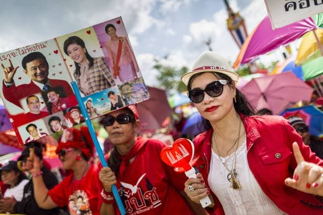 May 10, 2014 - Bangkok, Bangkok, Thailand - Supporters of Yingluck Shinawatra cheer at a Red Shirt rally in Bangkok. Thousands of Thai Red Shirts, members of the United Front for Democracy Against Dictatorship (UDD), members of the ruling Pheu Thai party and supporters of the government of ousted Prime Minister Yingluck Shinawatra are rallying on Aksa Road in the Bangkok suburbs. The government was ousted by a court ruling earlier in the week that deposed Yingluck because the judges said she acted unconstitutionally in a personnel matter early in her administration. Thailand now has no functioning government. Red Shirt leaders said at the rally Saturday that any attempt to impose an unelected government on Thailand could spark a civil war. This is the third consecutive popularly elected UDD supported government ousted by the courts in less than 10 years. - ZUMAk94
