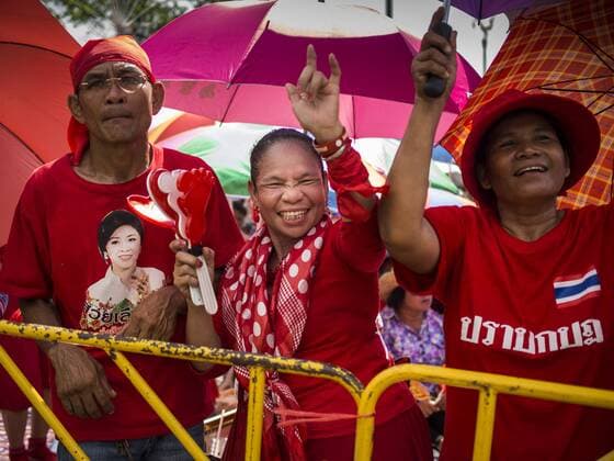 May 10, 2014 - Bangkok, Bangkok, Thailand - Supporters of Yingluck Shinawatra cheer at a Red Shirt rally in Bangkok. Thousands of Thai Red Shirts, members of the United Front for Democracy Against Dictatorship (UDD), members of the ruling Pheu Thai party and supporters of the government of ousted Prime Minister Yingluck Shinawatra are rallying on Aksa Road in the Bangkok suburbs. The government was ousted by a court ruling earlier in the week that deposed Yingluck because the judges said she acted unconstitutionally in a personnel matter early in her administration. Thailand now has no functioning government. Red Shirt leaders said at the rally Saturday that any attempt to impose an unelected government on Thailand could spark a civil war. This is the third consecutive popularly elected UDD supported government ousted by the courts in less than 10 years. - ZUMAk94