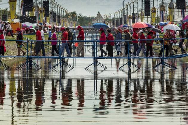 May 17, 2014 - Bangkok, Bangkok, Thailand - Supporters of the Red Shirts cross a khlong (canal) to get to a Red Shirt rally in Bangkok. Thousands of Thai Red Shirts, members of the United Front for Democracy Against Dictatorship (UDD), members of the ruling Pheu Thai party and supporters of the government of ousted Prime Minister Yingluck Shinawatra are rallying on Aksa Road in the Bangkok suburbs. The government was ousted by a court ruling earlier in the week that deposed Yingluck because the judges said she acted unconstitutionally in a personnel matter early in her administration. Thailand now has no functioning government. Red Shirt leaders said at the rally Saturday that any attempt to impose an unelected government on Thailand could spark a civil war. This is the third consecutive popularly elected UDD supported government ousted by the courts in less than 10 years. - ZUMAk94