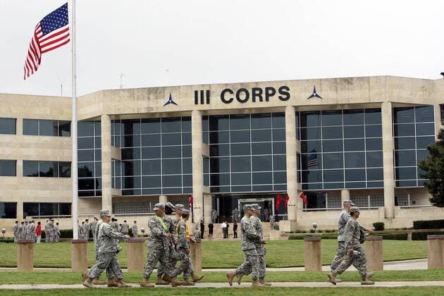 FOR METRO - U.S. Army soldiers pass III Corps headquarters where an American flag flies at half staff on Fort Hood Army Post Monday Nov. 9, 2009 in Fort Hood, Tx. PHOTO BY EDWARD A. ORNELAS eaornelas@express-news.net) - ZUMAa27_