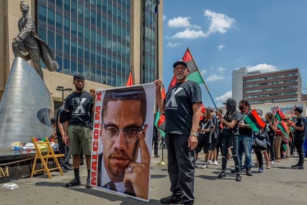 NYC: 28th Malcolm X march In honor of the 92nd Anniversary of the birth of black national hero, Malcolm X, on May 19, 2017; members of December 12th Movement, Black Lives Matter Greater New York and Harlem residents gathered outside Adam Clayton Powell State Office Building, 163 W. 125th St. to hold the 28th annual black power Shut ‘Em Down rally and march.  ErikxMcGregor