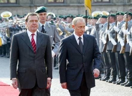 German Chancellor Gerhard Schroeder, left, and Russian President Vladimir Putin review the honour guard during the welcoming ceremony in Weimar, eastern Germany, Tuesday, April 9, 2002. Putin is on a two-day visit in Weimar for the German Russian consultations. ( Eckehard Schulz) WEIMAR DEU