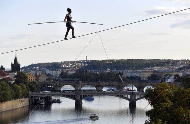 Entertainment Themen der Woche KW33 Entertainment Bilder des Tages French ropewalker Tatiana-Mosio Bongonga, from the Cie Basinga ensemble, crossed the Vltava River on a thin, 16-mm rope 35 metres above the water level in the centre in some 40 minutes at the opening of the Summer Letna international festival of new circus and theatre in Prague, Czech Republic, August 14, 2019. Thousands of people were watching and applauding her performance from the embankment, the Cech Bridge and the Letna park. Bongonga, 35, who has been waLking on the rope since the age of eight, crossed the Vltava (Moldau) River without any visible support, using a four-metre-long balance pole, weighing 12 kilos. (CTKxPhoto VitxSimanek) CTKPhotoP201908140796201 _VIS3928