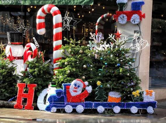 December 19, 2020, London, United Kingdom: Large display of Christmas trees and various Christmas decorations outside Hedonism wines in central London..Despite London being placed under extremely high Tier 4 restrictions to prevent the spread of Covid-19, with indoor venues, non essential retail and clubs all closed and inability to trade, there are many colourful Christmas displays around the city. London United Kingdom - ZUMAs197 20201219_zaa_s197_231 Copyright: xKeithxMayhewx