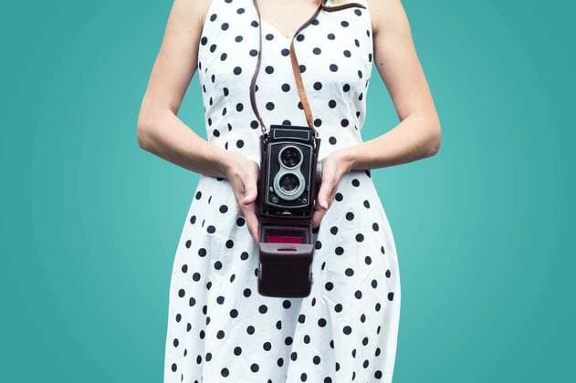 Close up of a woman in polka dress holding a camera, 26.10.2016 09:09:40, Copyright: xmacondox Panthermedia19188069