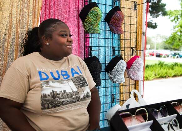 September 10, 2021, St. Petersburg, Florida, USA: Danasia Veney, 21, smiles while watching customers shop at the InSparkle Me booth at the St. Pete Pier Marketplace, 800 2nd Ave NE, on Friday, Sept. 10, 2021 in St. Petersburg. DanasiaÃ¢â‚¬â ¢s mom is the owner of the booth. St. Pete Pier has been open for a year and the retailers are succeeding and some are expanding to their own brick and mortar stores. St. Petersburg USA - ZUMAs70_ 20210910_zan_s70_031 Copyright: xDirkxShaddx