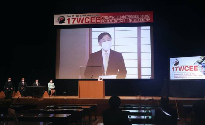 Japan Emperor Naruhito Japanese Emperor Naruhito is projected on a screen during the opening ceremony of the World Conference on Earthquake Engineering in Sendai in Miyagi Prefecture, northeastern Japan, on Sept. 28, 2021. The emperor attended the ceremony remotely from the Imperial Palace in Tokyo amid the coronavirus pandemic.  A14AA0000897584P