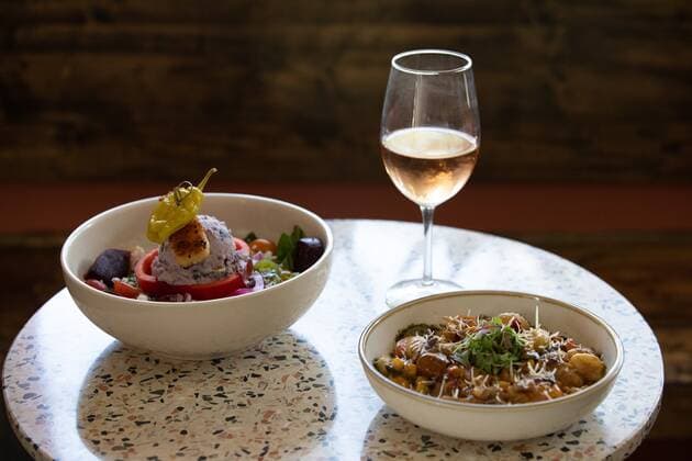 September 22, 2022, St.Petersburg, Florida, USA: A glass of roso , a bowl of Tarpon Greek Salad, and a bowl of seasonal gnocchi is displayed at Good Intentions, a newly opened vegan restaurant, on Thursday, Sept. 22, 2022, in St.Petersburg. St.Petersburg USA - ZUMAs70_ 20220922_zan_s70_055 Copyright: xAngelicaxEdwardsx