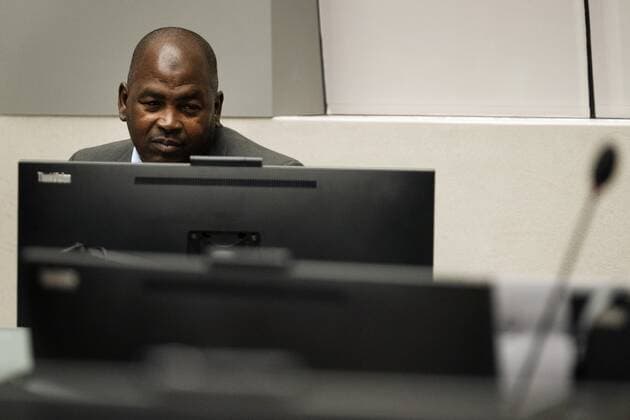 2022-09-26 09:32:48 Mahamat Said Abdel Kani takes his seat in the court room of the International Criminal Court in The Hague, Netherlands, Monday, Sept. 26, 2022. The trial of an alleged commander in a mainly Muslim rebel group from Central African Republic opened and charged Said with crimes against humanity and war crimes. (AP Photo Peter Dejong, Pool) netherlands out - belgium out