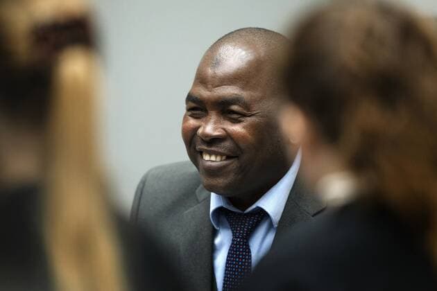 2022-09-26 09:25:12 Mahamat Said Abdel Kani talks to his defense lawyers in the court room of the International Criminal Court in The Hague, Netherlands, Monday, Sept. 26, 2022. The trial of an alleged commander in a mainly Muslim rebel group from Central African Republic opened and charged Said with crimes against humanity and war crimes. (AP Photo Peter Dejong, Pool) netherlands out - belgium out