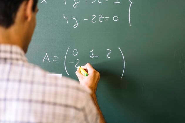 Math teacher solving problems on chalkboard model released, Symbolfoto, DAMF01093