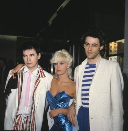 Left to Right: JOHNNIE FINGERS, British Musician, member of the Boomtown Rats; PAULA YATES, British Model and Journalist and her boyfriend BOB GELDOF, Irish Pop Singer, member of the Boomtown Rats COMPULSORY CREDIT: UPPA Photoshot Photo CGP 102635 05 Left to Right: JOHNNIE FINGERS, British Musician, member of the Boomtown Rats; PAULA YATES, British Model and Journalist and her boyfriend BOB GELDOF, Irish Pop Singer, member of the Boomtown Rats COMPULSORY CREDIT: Starstock Photoshot Photo CGP 102635 05.06.1979, Credit:Photoshot Avalon United Kingdom  Copyright: xPhotoshotx xAvalonx 0506395672