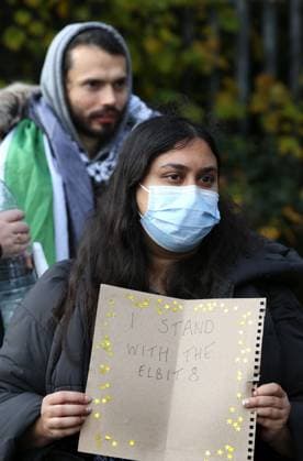 November 13, 2023, London, United Kingdom: A supporter joins the gathering outside the court and holds a sign which says ˜I Stand With The Elbit 8™ .Palestinian Actionists known as ˜The Elbit Eight™ are facing conspiracy charges to commit criminal damage, burglary and some of them, blackmail, against Israeli arms company Elbit systems. The charges go back to 2020. Six weeks have been set aside at court. Palestine Action believe that Elbit™s businesses in the UK manufacture drones that are being used in Gaza and elsewhere against the Palestinian people. Their direct actions against Elbit Systems in the UK have already seen two of their 10 sites closed down. London United Kingdom - ZUMAs197 20231113_aaa_s197_434 Copyright: xMartinxPopex