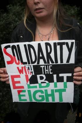 November 13, 2023, London, United Kingdom: A supporter stands outside the court and holds a sign which says ˜Solidarity With The Elbit Eight™ .Palestinian Actionists known as ˜The Elbit Eight™ are facing conspiracy charges to commit criminal damage, burglary and some of them, blackmail, against Israeli arms company Elbit systems. The charges go back to 2020. Six weeks have been set aside at court. Palestine Action believe that Elbit™s businesses in the UK manufacture drones that are being used in Gaza and elsewhere against the Palestinian people. Their direct actions against Elbit Systems in the UK have already seen two of their 10 sites closed down. London United Kingdom - ZUMAs197 20231113_aaa_s197_448 Copyright: xMartinxPopex