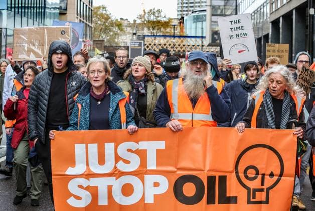November 18, 2023, London, United Kingdom: Supporters of Just Stop Oil march across London behind large banners saying Just Stop Oil Just Stop Oil march across London to highlight the need to change the way we depend on oil and gas for energy. They argue that time is running out for the planet and immediate change away from fossil fuels is necessary. They state the government is imprisoning peaceful protestors and protecting the real criminals, rewarding them by licensing more than 100 new oil and gas projects. London United Kingdom - ZUMAs197 20231118_aaa_s197_127 Copyright: xMartinxPopex