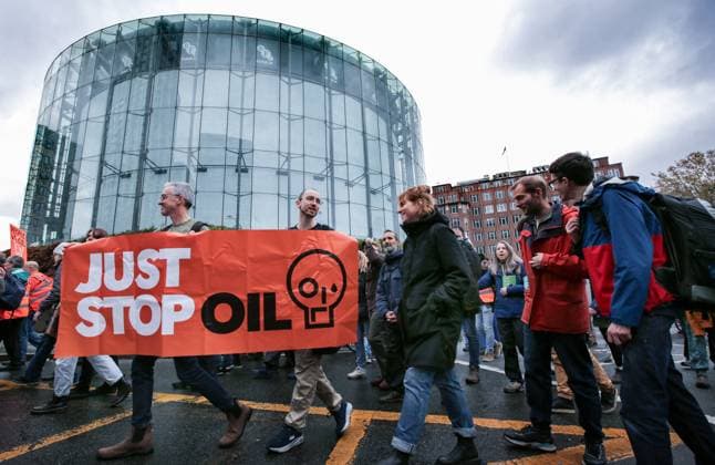 November 18, 2023, London, United Kingdom: Supporters of Just Stop Oil march across London behind large banners saying Just Stop Oil . Just Stop Oil march across London to highlight the need to change the way we depend on oil and gas for energy. They argue that time is running out for the planet and immediate change away from fossil fuels is necessary. They state the government is imprisoning peaceful protestors and protecting the real criminals, rewarding them by licensing more than 100 new oil and gas projects. London United Kingdom - ZUMAs197 20231118_aaa_s197_132 Copyright: xMartinxPopex