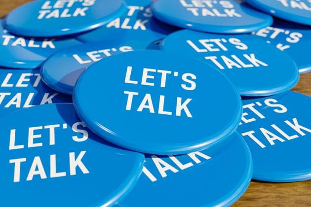 Let s talk. Let s talk. Blau badges laying on the table with the message let s talk . Communication, discussion, speech, talking.3D illustration badge007s021_lets_talk