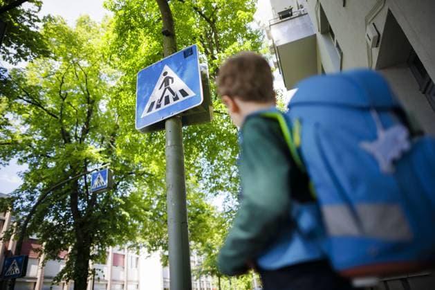 Symbolfoto zum Thema Schulkind im Strassenverkehr. Ein sechsjaehriger Junge steht mit seinem Schulranzen auf dem Ruecken vor dem Schild eines Fussgaengerueberweges vor einer Grundschule. Berlin, 08.05.2024. Berlin Deutschland Copyright: xThomasxTrutschelxphotothek.dex