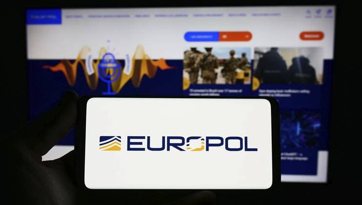 Stuttgart, Germany, 04-02-2023: Person holding smartphone with logo of EU law enforcement agency Europol on screen in front of website. Focus on phone display, Europe Copyright: imageBROKER TimonxSchneider ibliqx10709350.jpg