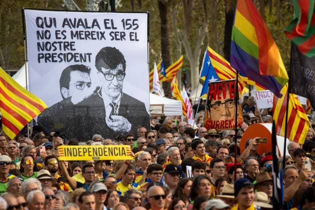 September 11, 2024, Barcelona, Spain: A man carries a sign with the word independence in front of a banner that says in Catalan Whoever approved 155 does not deserve to be our president with the face of the current President of the Generalitat of Catalonia, Salvador Illa (L) next to that of Pere Aragones (R), Illa s predecessor in office, to the right another protester carries a banner with the face of the former president of the generalitat, fugitive from justice, Carles Puigdemont, during the celebration of the Diada de Catalunya. As every September 11th, the Catalan National Day, also known as Catalonia Day or National Day of Catalonia, was celebrated in the city of Barcelona..In the morning, the traditional floral offering was made - ZUMAs197 20240911_aaa_s197_401 Copyright: xDavidxCanalesx