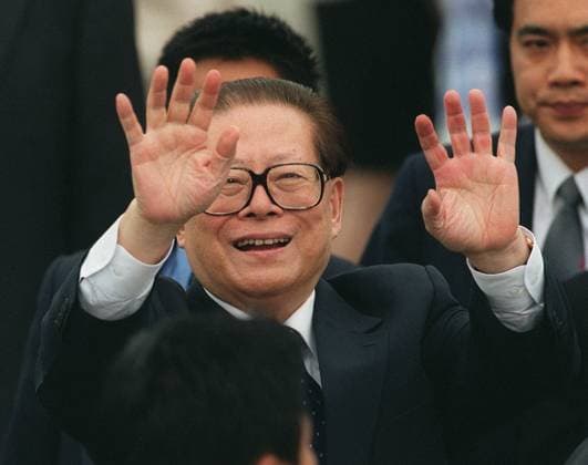 President Jiang Zemin of the People s Republic of China waves goodbye to the press at the Hong Kong International Airport before he enters the plane leaving Hong Kong. He has come to Hong Kong for a short visit and for attending the Fortune Global Forum.
