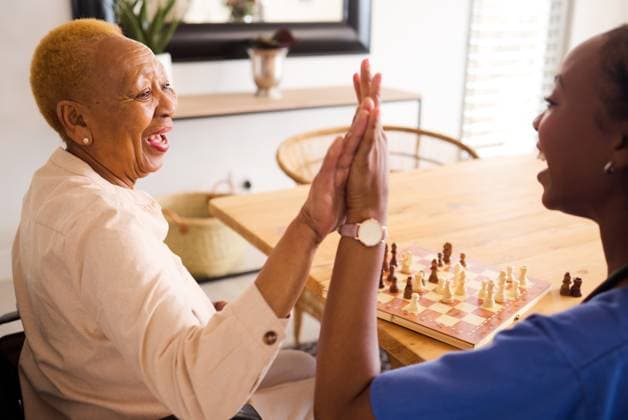 Black people, nurse and high five in elderly care for chess, fun or social activity or game together at home. African medical professional touching hands with senior female person with a disability., model released, , 56013648.jpg, black, people, nurse, high, female, home, african, senior, hands, medical, hand, fun, person, care, together, elderly, at home, professional, social, game, touching, chess, black people, elder, activity, disability, medic, medical professional, high five, elderly care, happy, doctor, smile, team, working, meeting, healthy, health, worker, teamwork, healthcare, success, job, wellness, support, surgery, excited, leader, medicine, collaboration RECORD DATE NOT STATED