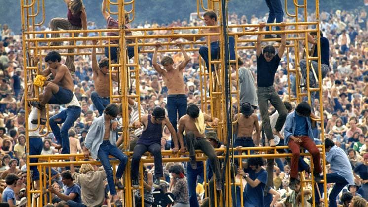 Woodstock: Three Days That Defined a Generation - filmstill Woodstock: Three Days That Defined a Generation Bethel, New York: August 1969. Crowd and people sitting on the sound tower - - - EDITORIAL USE ONLY Copyright: xElliotxLandyx