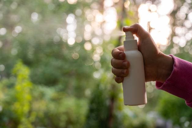 Person spraying insect repellent at her hand outdoors during summer. Trying to kill mosquitoes and flies. Clearly visible spray droplets. Prevention disinfection against mosquito bite Person spraying insect repellent at her hand outdoors during summer. Trying to kill mosquitoes and flies. Clearly visible spray droplets. Prevention disinfection against mosquito bite during sunny day., 96445050.jpg RECORD DATE NOT STATED