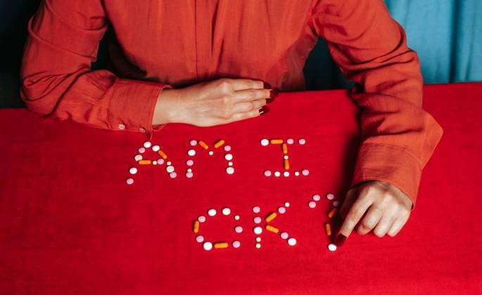 Hand arranging pills spelling out a question about mental health model released, Symbolfoto, AAF00194