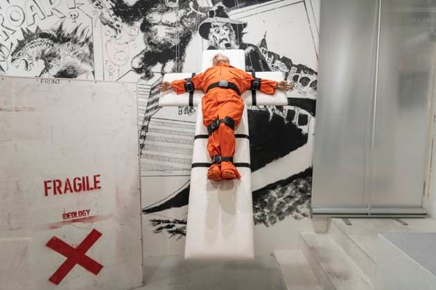 November 8, 2025, Basel, Basel-Stadt, Switzerland: A sculpture depicting the US President Donald Trump in a prisoner orange jumpsuit and strapped to a cross looking like a death row strapped-down bed, is displayed in a gallery of the city centre of Basel, Switzerland Basel Switzerland - ZUMAp199 20251108_zip_p199_002 Copyright: xMatteoxPlacuccix