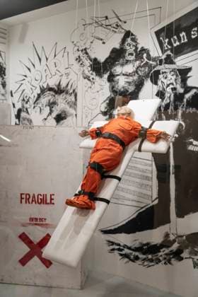 November 8, 2025, Basel, Basel-Stadt, Switzerland: A sculpture depicting the US President Donald Trump in a prisoner orange jumpsuit and strapped to a cross looking like a death row strapped-down bed, is displayed in a gallery of the city centre of Basel, Switzerland Basel Switzerland - ZUMAp199 20251108_zip_p199_007 Copyright: xMatteoxPlacuccix