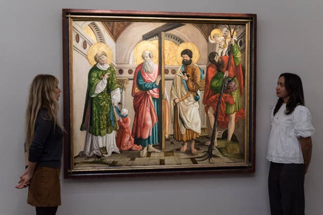 November 28, 2025, London, England, United Kingdom: Staff members look at a painting titled Saints Stephen, Andrew, Paul and Christopher, within an architectural setting by Circle of Hans Leonard Scho¤ufelein, estimate: 80,000 - 120,000 GBP during a photocall at Sotheby s auction house ahead of Old Master & 19th Century Paintings Sales. London United Kingdom - ZUMAs371 20251128_zip_s371_010 Copyright: xWiktorxSzymanowiczx