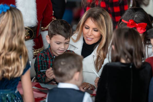 December 8, 2025, Quantico, Virginia, USA: A young boy sits on First Lady MELANIA TRUMPÃ¢â‚¬â ¢s lap as they make holiday cards together during a Toys for Tots event at Marine Corps Base Quantico. Quantico USA - ZUMAs365 20251208_znp_s365_005 Copyright: xJoeyxSussmanx