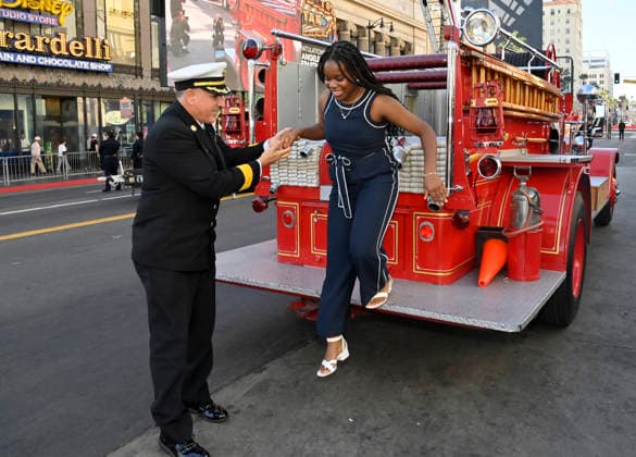Steven Nissen, President & CEO, Hollywood Chamber of Commerce (R) and Eniola Taiwo participate in an unveiling ceremony honoring the Los Angeles Fire Department with an Award of Excellence star adjacent to the Hollywood Walk of Fame in Los Angeles on Tuesday, December 2, 2025. Taiwo, 14, wrote a letter to the Hollywood Chamber of Commerce suggesting that firefighters who battled the deadly January fires were worthy of a star on the Hollywood Walk of Fame. The letter precipitated tribute.  LAP2025121228 JIMxRUYMEN