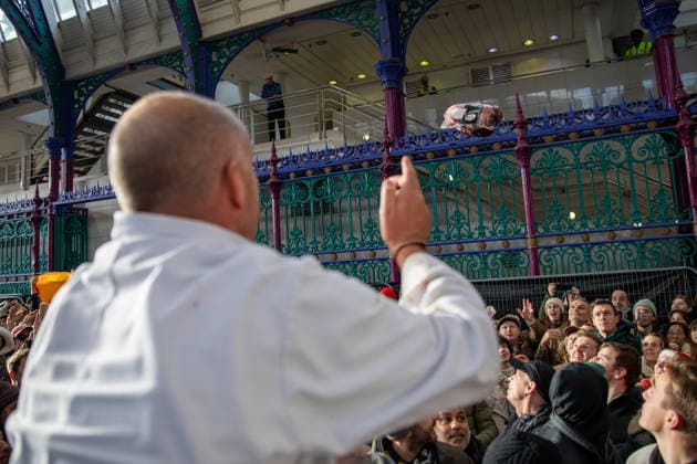 December 24, 2025, London, United Kingdom: A joint of meat is thrown to a member of the public during the annual Smithfield Market Christmas Eve auction. Members of the public attend the annual Smithfield Market Meat Auction. Held every Christmas eve, the tradition organised by individual suppliers, butchers and porter™s auction off surplus prime cuts of meat at a reduced price. The 900-year-old market situated in the City of London faces an uncertain future as the site has been marked for re-development with the market being moved to another of part of London. London United Kingdom - ZUMAs197 20251224_aaa_s197_133 Copyright: xJamesxWilloughbyx