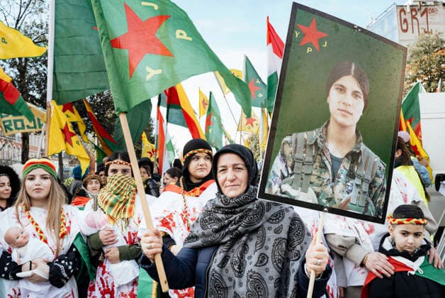 Rally in support of the Revolution in Rojava - Toulouse Rally in support of International Solidarity for Rojava asking action against the massacre of the Kurds, in Toulouse, France, on January 31, 2026. A woman in the foreground, Ms. Atac, holding the YPJ flag, Women s Protection Units, in one hand and a poster of a female warrior in the other, with women behind her wearing white dresses stained with blood on their hands, some with babies in their arms. Rally in support of the revolution in Rojava, a semi-autonomous region in northeastern Syria, which is under attack by the new regime seeking to extend its authority over Kurdish-administered territories. Photo by Patricia Huchot-Boissier ABACAPRESS.COM TOULOUSE OCCITANIE France Copyright: xHuchot-BoissierxPatricia ABACAx
