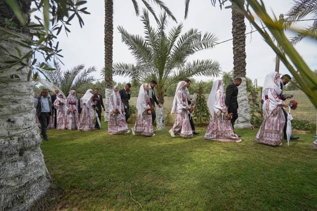 150 couples got married in a mass wedding ceremony in Deir al-Balah DEIR AL-BALAH, GAZA, PALESTINE - APRIL 24: Couples are seen in line as mass wedding ceremony organized by the United Arab Emirates under the ‘Al-Fares Al-Shahem’ initiative where 150 Palestinian couples got married in Deir al-Balah, Gaza, Palestine, on April 24, 2026. Adam Bilal Anadolu Deir al-Balah Gaza. Editorial use only. Please get in touch for any other usage.  Copyright: x2026xAnadoluxAdamxBilalx