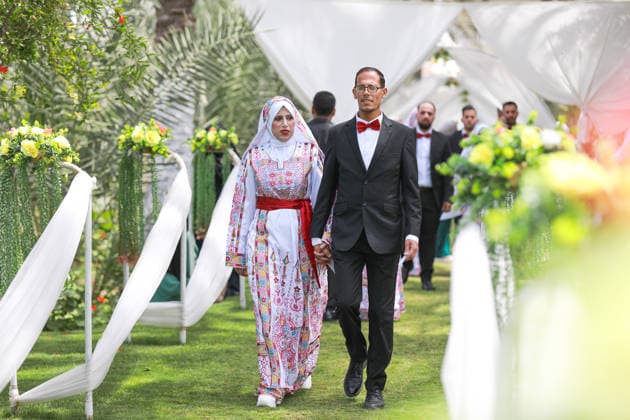 150 couples got married in a mass wedding ceremony in Deir al-Balah DEIR AL-BALAH, GAZA, PALESTINE - APRIL 24: A couple walks as mass wedding ceremony organized by the United Arab Emirates under the ‘Al-Fares Al-Shahem’ initiative where 150 Palestinian couples got married in Deir al-Balah, Gaza, Palestine, on April 24, 2026. Adam Bilal Anadolu Deir al-Balah Gaza. Editorial use only. Please get in touch for any other usage.  Copyright: x2026xAnadoluxAdamxBilalx