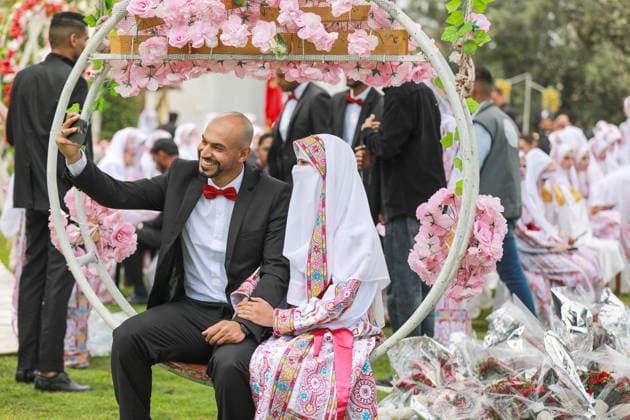 150 couples got married in a mass wedding ceremony in Deir al-Balah DEIR AL-BALAH, GAZA, PALESTINE - APRIL 24: A couple poses for a selfie as mass wedding ceremony organized by the United Arab Emirates under the ‘Al-Fares Al-Shahem’ initiative where 150 Palestinian couples got married in Deir al-Balah, Gaza, Palestine, on April 24, 2026. Adam Bilal Anadolu Deir al-Balah Gaza. Editorial use only. Please get in touch for any other usage.  Copyright: x2026xAnadoluxAdamxBilalx