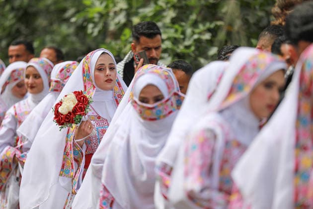 150 couples got married in a mass wedding ceremony in Deir al-Balah DEIR AL-BALAH, GAZA, PALESTINE - APRIL 24: Couples are seen as mass wedding ceremony organized by the United Arab Emirates under the ‘Al-Fares Al-Shahem’ initiative where 150 Palestinian couples got married in Deir al-Balah, Gaza, Palestine, on April 24, 2026. Adam Bilal Anadolu Deir al-Balah Gaza. Editorial use only. Please get in touch for any other usage.  Copyright: x2026xAnadoluxAdamxBilalx