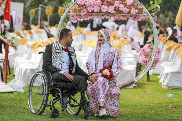 150 couples got married in a mass wedding ceremony in Deir al-Balah DEIR AL-BALAH, GAZA, PALESTINE - APRIL 24: A couple is seen as mass wedding ceremony organized by the United Arab Emirates under the ‘Al-Fares Al-Shahem’ initiative where 150 Palestinian couples got married in Deir al-Balah, Gaza, Palestine, on April 24, 2026. Adam Bilal Anadolu Deir al-Balah Gaza. Editorial use only. Please get in touch for any other usage.  Copyright: x2026xAnadoluxAdamxBilalx