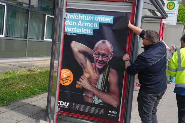 Protestplakate gegen die CDU am Rande der CDA Bundestagung Mitarbeiter der Stadt Marburg entfernen willkuerlich angebrachte Protestplakate gegen Bundeskanzler Merz und die CDU an einer Bushaltestelle gegenueber der Veranstaltungshalle zur 41. Bundestagung der CDA in Marburg, 25.04.2026 Marburg Hessen Deutschland