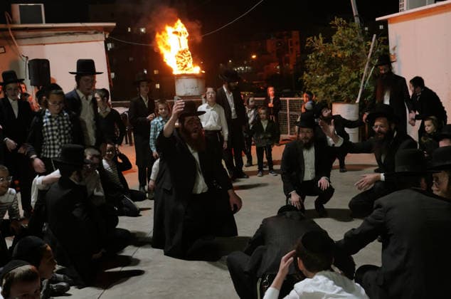 (260505) -- MODI IN, May 5, 2026 -- Ultra-Orthodox Jewish people attend a fire burning ceremony as they celebrate the Jewish holiday of Lag BaOmer in Modi in, Israel, May 4, 2026. (Photo by Xinhua) ISRAEL-MODI IN-LAG BAOMER-CELEBRATION GilxCohenxMagen 