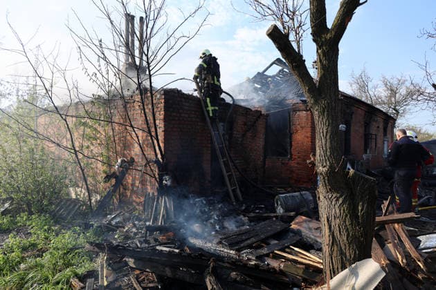 A firefighter pours water on smouldering wooden beams on the roof of a private house that caught fire after being hit by a Russian strike drone, Kharkiv, Ukraine, May 6, 2026. On Wednesday morning, Russian troops attacked Kharkiv with Shahed-type drones. Strikes on residential areas in the Novobavarskyi and Shevchenkivskyi districts injured two people.(Photo by Viacheslav Madiievskyi Ukrinform) Russian drone destroys house in Kharkiv  Copyright: xViacheslavxMadiievskyix