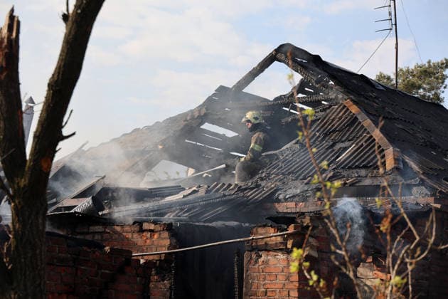 A firefighter pours water on smouldering wooden beams on the roof of a private house that caught fire after being hit by a Russian strike drone, Kharkiv, Ukraine, May 6, 2026. On Wednesday morning, Russian troops attacked Kharkiv with Shahed-type drones. Strikes on residential areas in the Novobavarskyi and Shevchenkivskyi districts injured two people.(Photo by Viacheslav Madiievskyi Ukrinform) Russian drone destroys house in Kharkiv  Copyright: xViacheslavxMadiievskyix