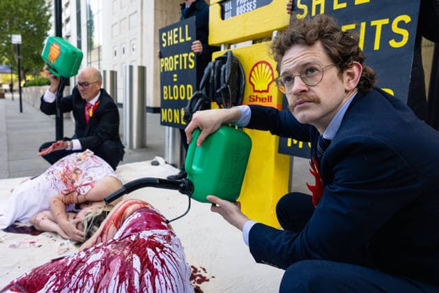 Climate Activists Pour Fake Blood over Protesters at Mock Petrol Pump outside Shell Centre, London, UK 6 May 2026 Activists lie on the ground in front of a mock petrol pump reading Oil Profit$$$ for Oil Bo$$es as they are doused in red liquid resembling blood outside the Shell Centre, London, UK, on 6 May 2026, during a Fossil Free London protest targeting Shell ahead of an expected jump in quarterly profits amid the US-Iran conflict., Credit:Pete Speller Avalon London, United Kingdom  Copyright: xPetexSpellerx xAvalonx 1096871598