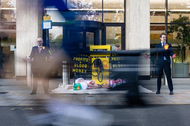 Climate Activists Pour Fake Blood over Protesters at Mock Petrol Pump outside Shell Centre, London, UK 6 May 2026 Activists lie on the ground in front of a mock petrol pump reading Oil Profit$$$ for Oil Bo$$es as they are doused in red liquid resembling blood outside the Shell Centre, London, UK, on 6 May 2026, during a Fossil Free London protest targeting Shell ahead of an expected jump in quarterly profits amid the US-Iran conflict., Credit:Pete Speller Avalon London, United Kingdom  Copyright: xPetexSpellerx xAvalonx 1096871614