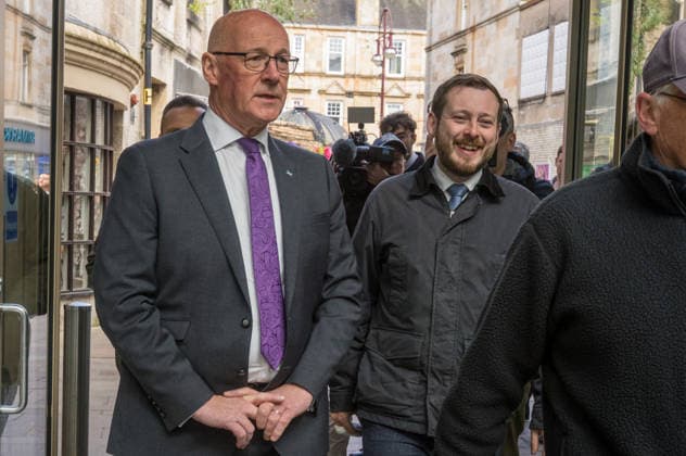 First Minister of Scotland John Swinney joins SNP candidate Alex Kerr campaigning in Hamilton - 06 May 2026 First Minister of Scotland John Swinney (left) and SNP candidate Alex Kerr (right) walk together through the constituency. The day before the Scottish parliamentary elections, First Minister of Scotland John Swinney visits Hamilton in South Lanarkshire, the constituency of SNP candidate Alex Kerr to kick off the final day of campaigning by meeting potential voters and owners of local businesses. Hamilton United Kingdom Copyright: xNeilxMiltonx xSOPAxImagesx L1000795